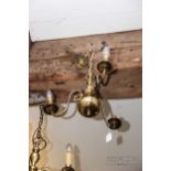A brass three-branch drop ceiling light, with candle effect lights