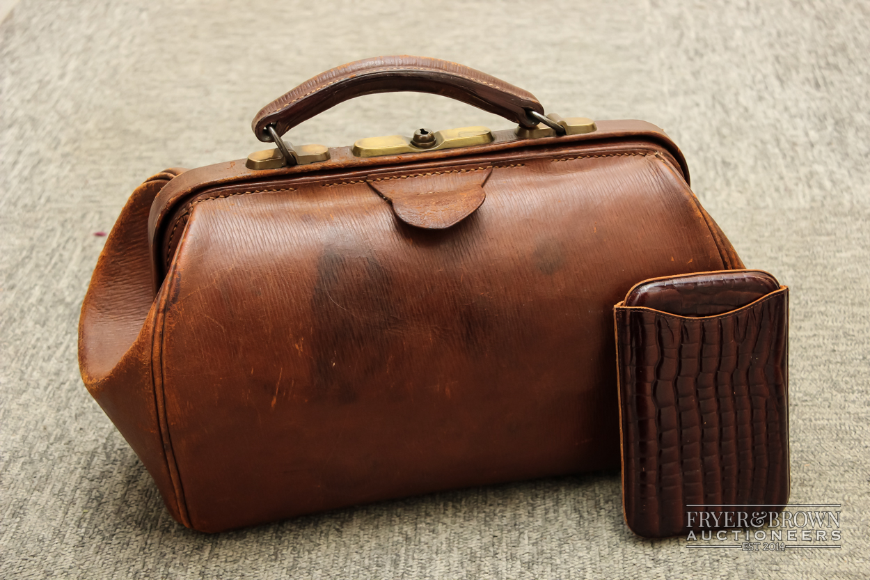 A vintage brown leather bag; and a leather cigar case with faux crocodile patent finish (2)