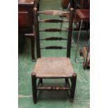 A Victorian ebonised low kitchen chair with rush seat