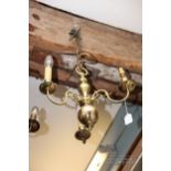 A brass three-branch drop ceiling light, with candle effect lights