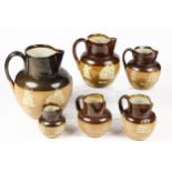 Six various Doulton stoneware jugs, sprigged with topers, 18.5cm high and smaller (6)