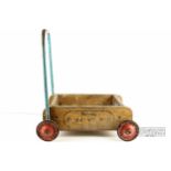 A vintage child's toy push cart