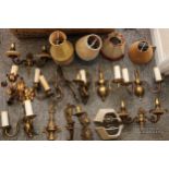 A quantity of antique and vintage brass wall light fittings and shades (qty)