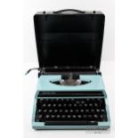 A silver Reed SR180 Deluxe portable typewriter, in case
