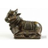 An Indian bronze figure of the sacred bull Nandi, modelled with ornate headdress and numnah,