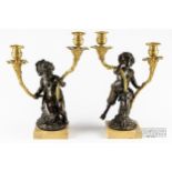 A pair of 19th century Louis XV style patinated and gilt bronze two-light candelabra, c1850, after