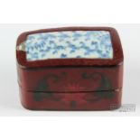 A Chinese red lacquer box, decorated with incised motifs of flowers and leaves, a blue & white