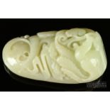 A Chinese mutton fat jade boulder carving, the small boulder carved with a ho ho bird amongst