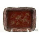 A Japanese lacquered metal tray, framed with basket work edge, with prunus and bird motif to centre,