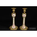 A pair of gilt metal mounted English porcelain candlesticks, the porcelain painted with polychrome