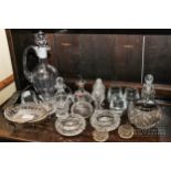A group of glass table wares, including a claret jug, cruets, salts, bitters bottles, ashtrays, etc.