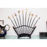 A small fan shaped display rack for six miniature replica spears, each with a different type of