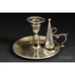 A silver William IV chamber stick and snuffer, circular base with reeded rim, makers mark HC for