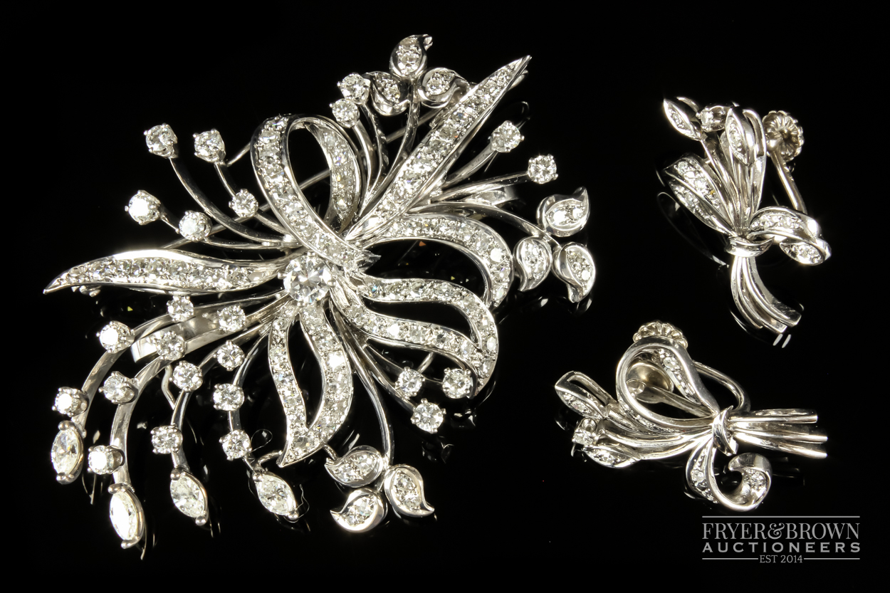 A 1950s diamond and white gold spray brooch/pendant, the bouquet scroll set throughout with