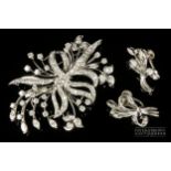 A 1950s diamond and white gold spray brooch/pendant, the bouquet scroll set throughout with