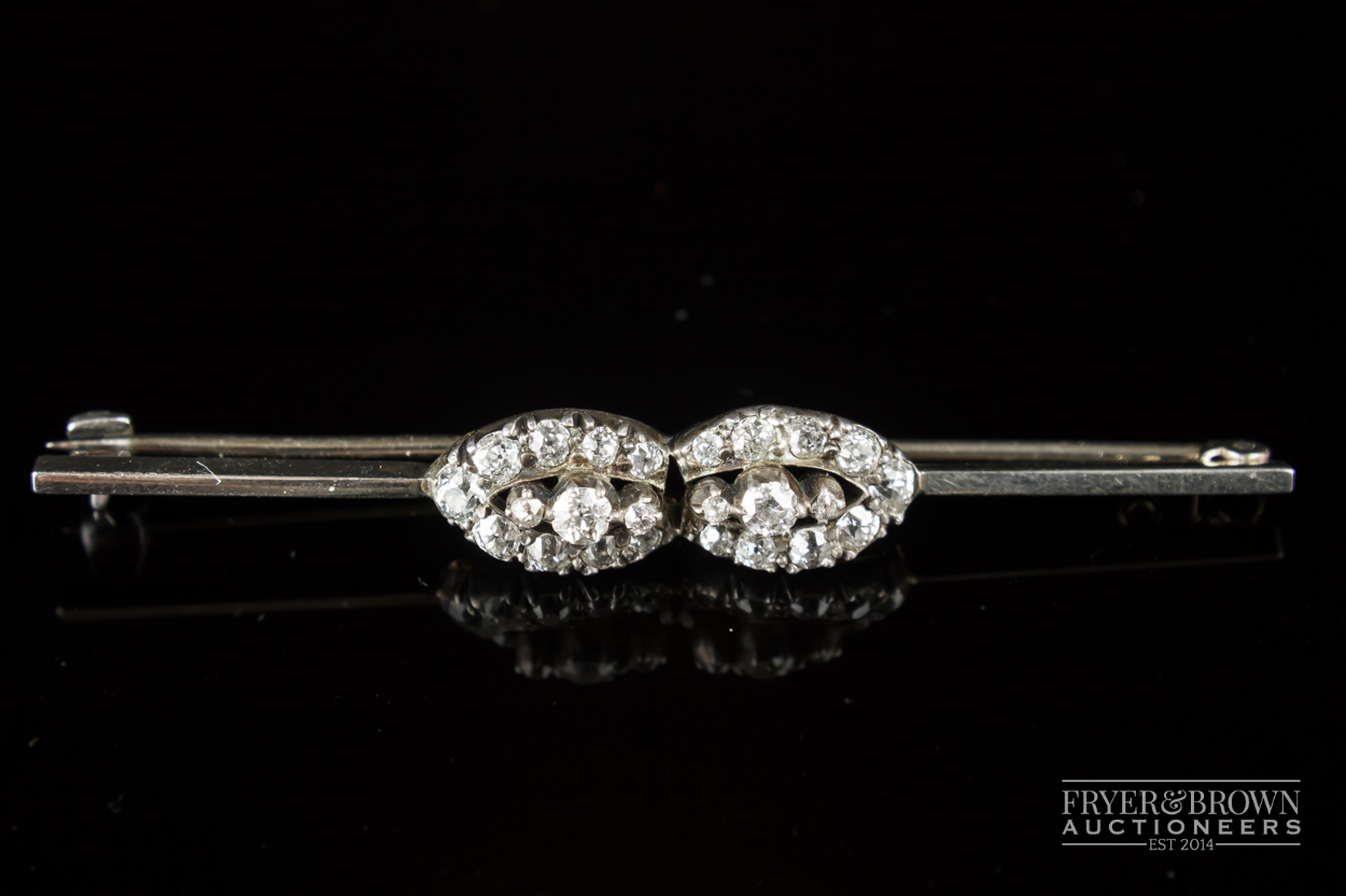 A diamond cluster bar brooch, c1915, the white gold bar pin set to the centre with two marquise