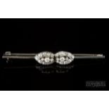 A diamond cluster bar brooch, c1915, the white gold bar pin set to the centre with two marquise