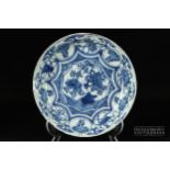 A Chinese blue & white porcelain saucer dish, painted with a central reserve of flowering trees