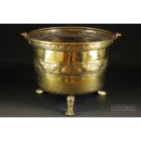 An 18th century Dutch brass coal bucket, of cauldron form on three paw feet, with repousse band of