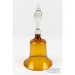 An amber glass frigger bell with colourless glass handle, 29cm high