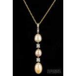 An 18ct gold, diamond and coloured pearl pendant, set with three slightly graduated pearls of