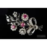 A 1940s ruby, diamond and 18ct white gold brooch, designed as a flower spray with diamond and ruby