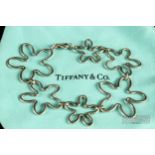 Tiffany & Co. - a silver bracelet, composed of six graduated irregular cinquefoil motifs, signed T &