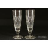 Two cut glass ale glasses, diamond banding over fluting, star cut bases, 18cm high