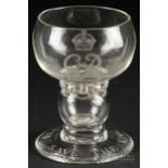 A George VI coin glass, of squat firing glass form with a ring of air inclusions below the bowl, the