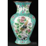 A Chinese enamel vase, of baluster form decorated with reserves of birds amidst flowering shrubs