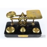 A set of brass and ebonised wood postal scales, with presentation plate dated 1901, 22.5cm max.