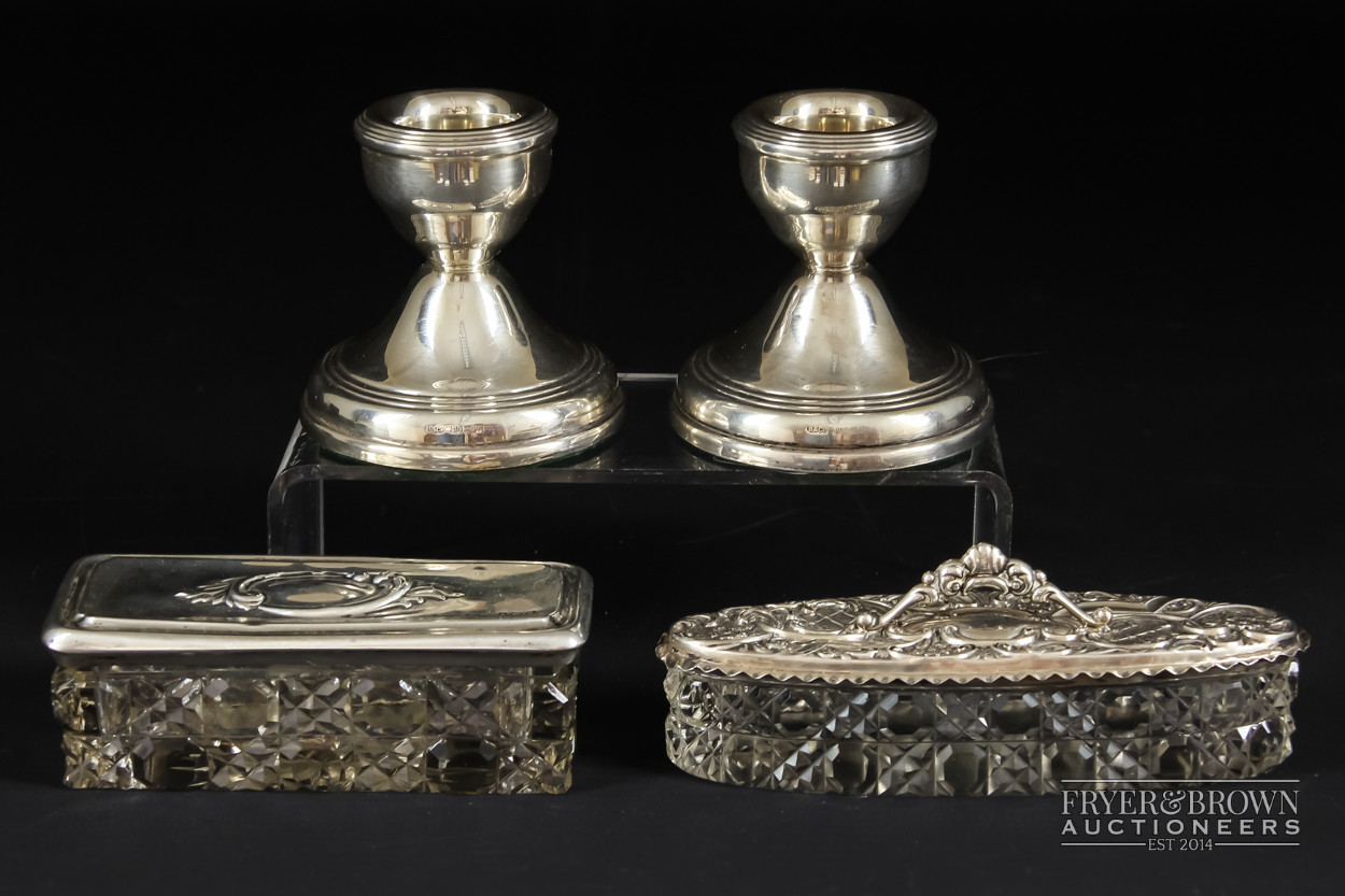 A pair of dwarf candlesticks, makers mark B & Co., Birmingham 1909; and two silver topped cut
