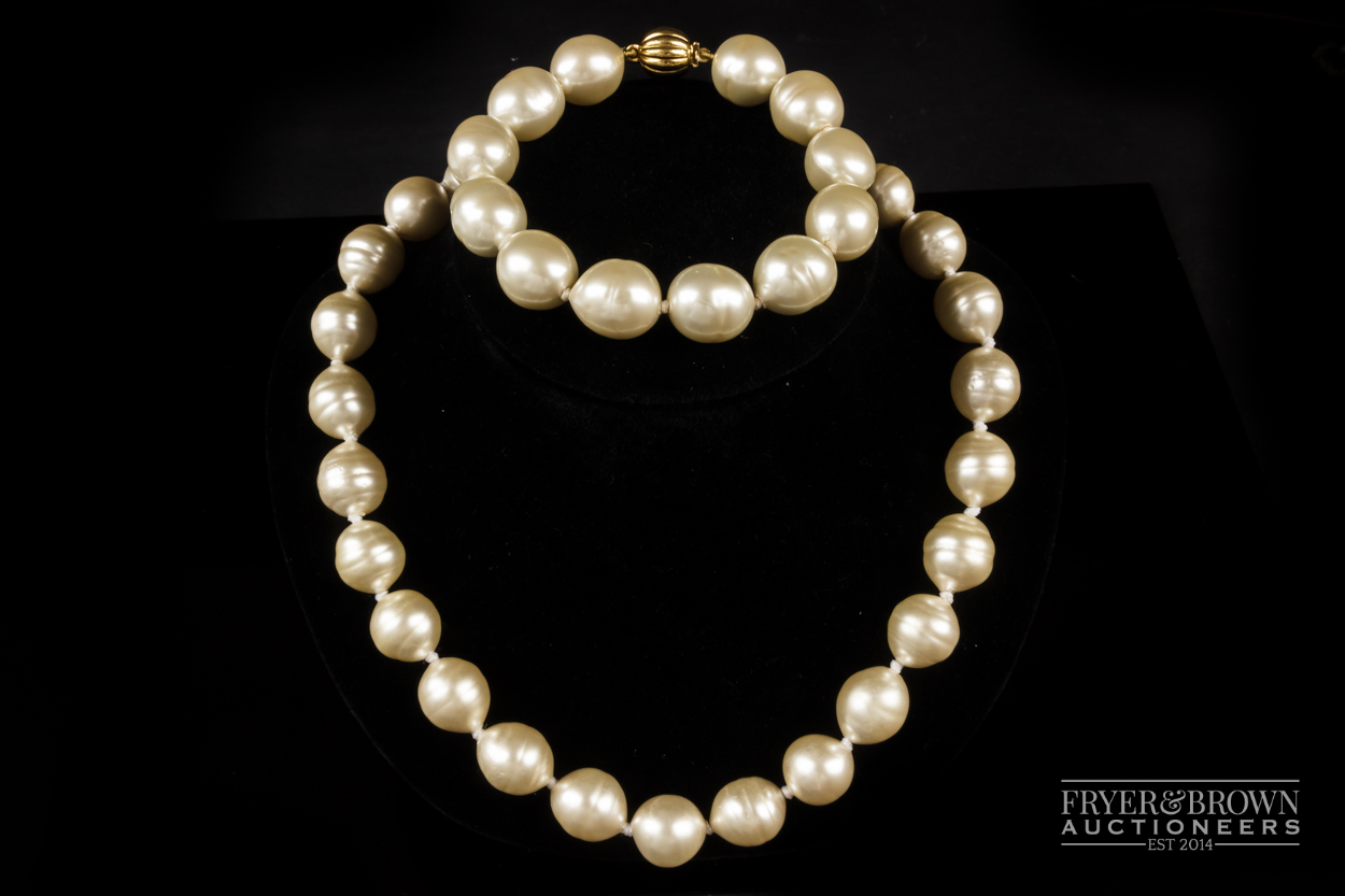 Ciro - a necklace of a uniform row of faux South Sea baroque pearls; and a matching bracelet, both