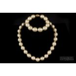 Ciro - a necklace of a uniform row of faux South Sea baroque pearls; and a matching bracelet, both