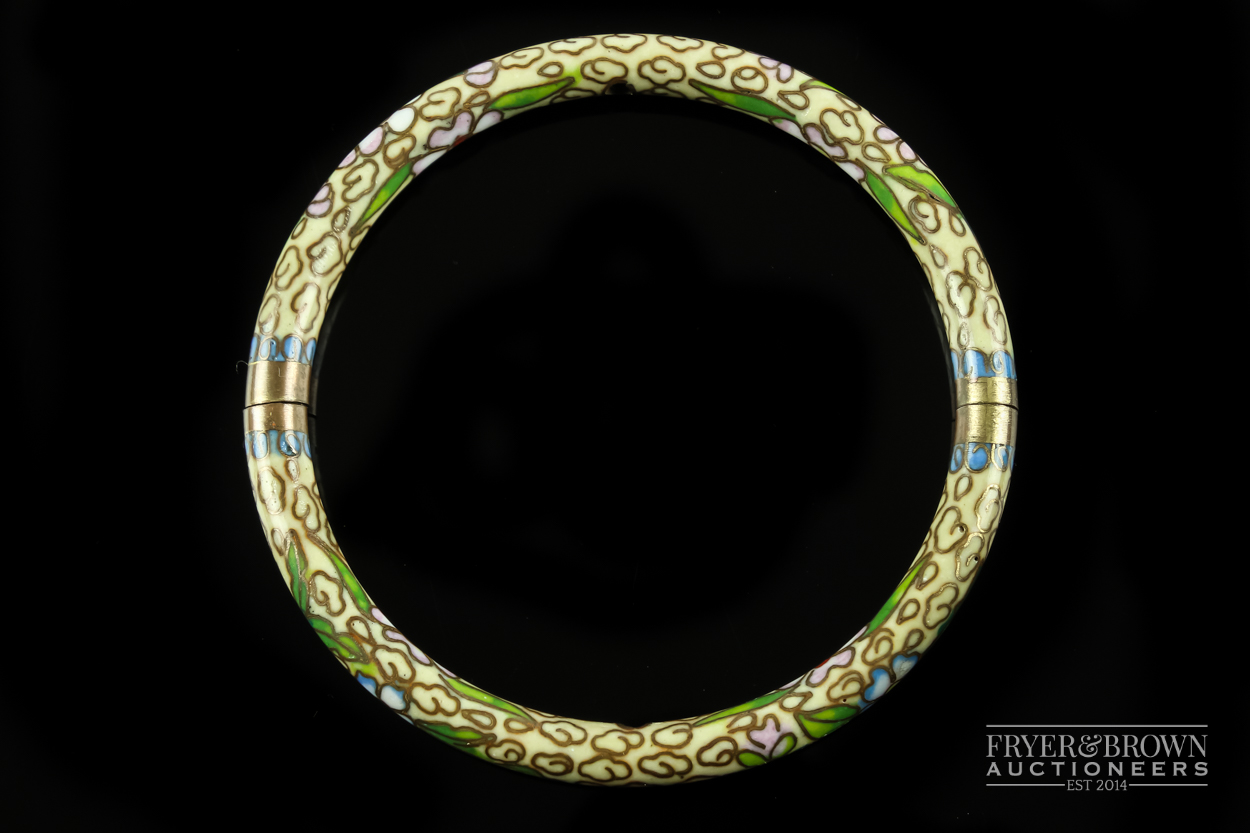 A Japanese cloisonne hinged bangle, the ivory coloured ground decorated with stylised cloud motifs