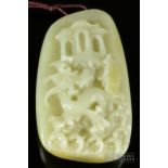 A Chinese mutton fat jade pendant, carved with a stylised lion/dragon amidst waves, 6.5cm