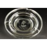 A Kosta Boda colourless glass large ashtray, engraved with a shell boat with star, 22cm diameter