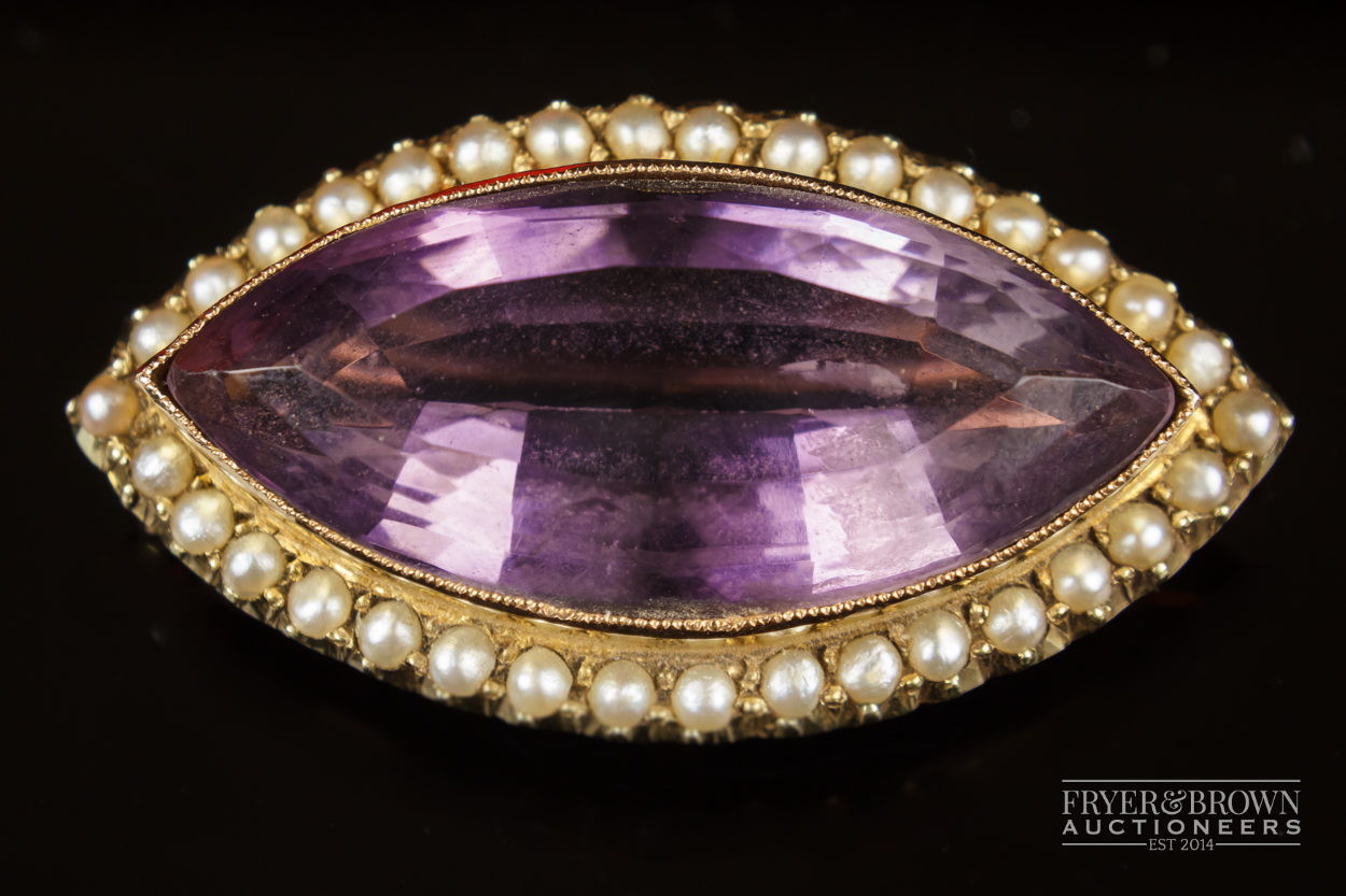 A 15ct gold antique amethyst and split pearl brooch, c1880, the marquise shaped mixed cut amethyst