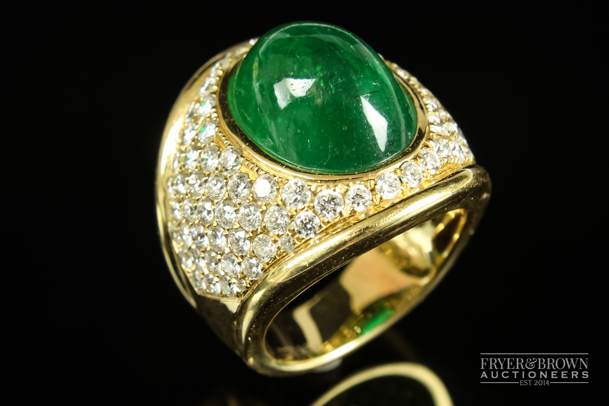 Kiki McDonough - a fine and impressive cabochon emerald and diamond ring, the oval shaped