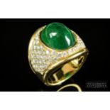 Kiki McDonough - a fine and impressive cabochon emerald and diamond ring, the oval shaped