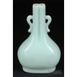 A Chinese monochrome Qingbai type glaze vase, Qianlong, the moulded vase of flattened pear shape