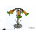 A spelter table lamp in Art Nouveau style, modelled as stylised flowers, five arms with frosted