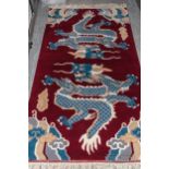 Two Indian rugs of Oriental design, the burgundy ground with design of two dragons with four claws