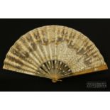 A Victorian fan, the horn sticks and guards with decoration picked out in gold and silver, with