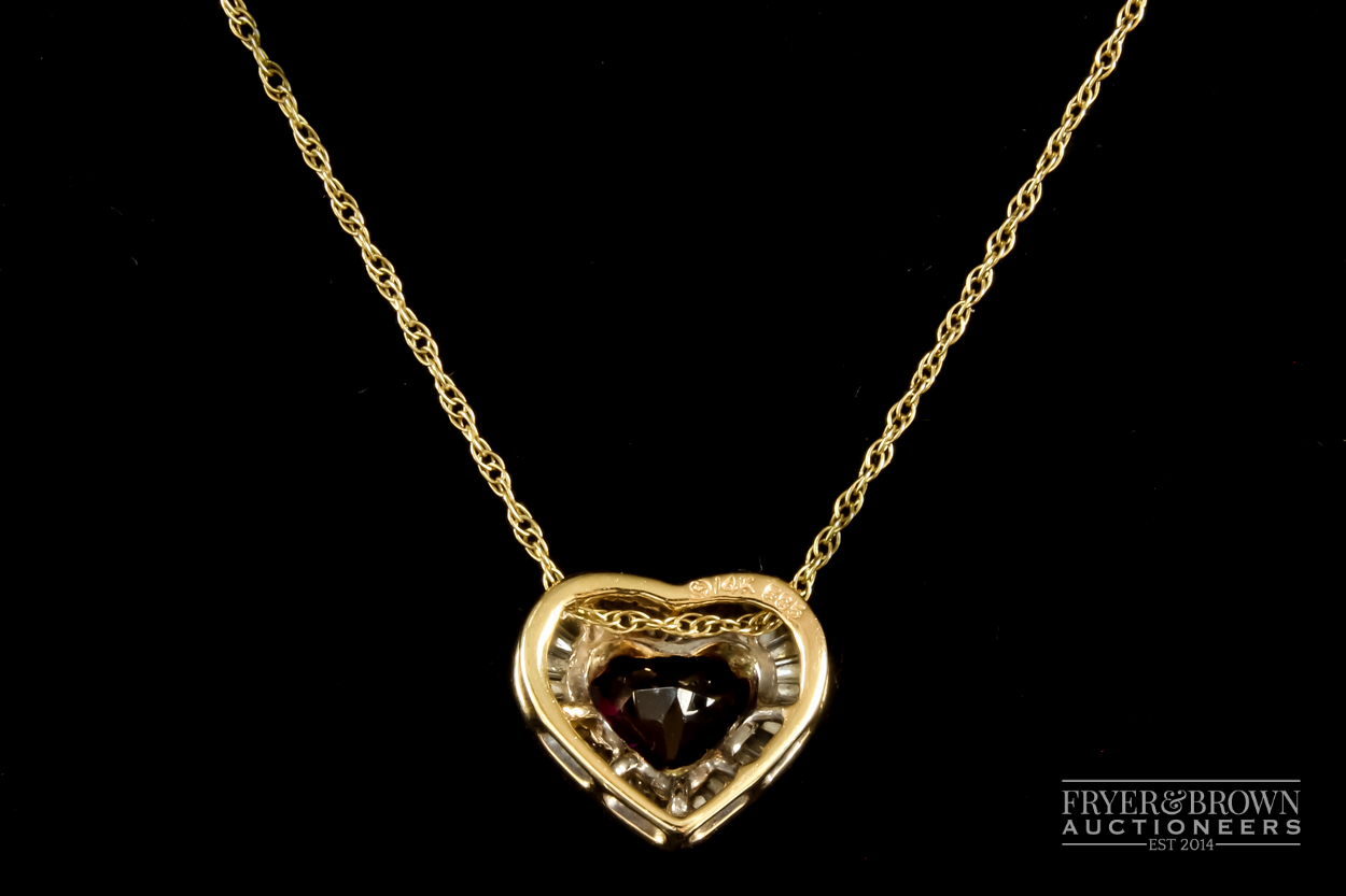 A heart shaped almandine garnet and calibre baguette diamond pendant, the heart shaped garnet of - Image 3 of 3