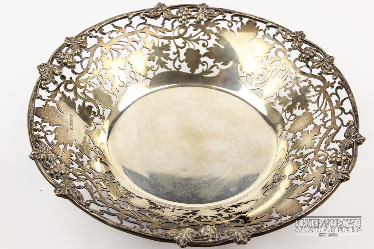 A silver grape basket, circular, pierced and cast with fruiting vines, makers mark PP Ltd.,