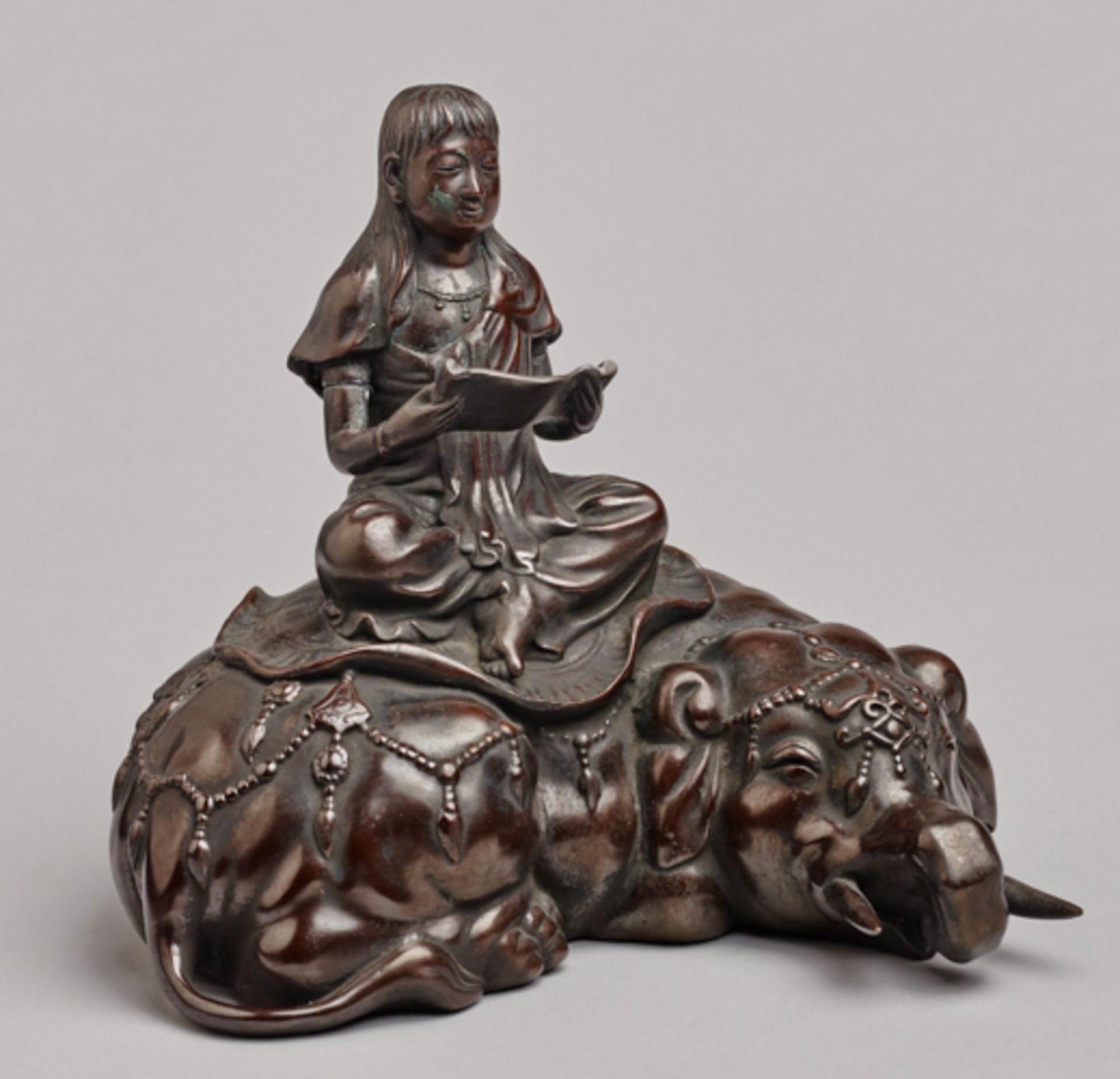 MAIDEN WITH SCROLL ON AN ELEPHANT  Bronze. Japan, Meiji-period (1868 - 1912)  Large, decoratively