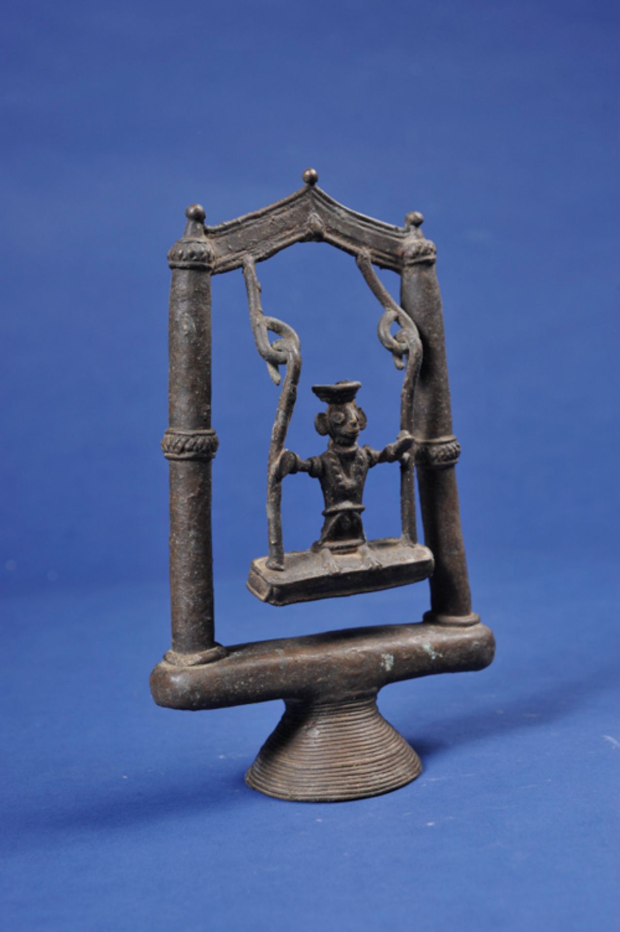 DEITY ON SWING  Bronze. India, approx. 19th century  Bronze figure depicting a female deity seated