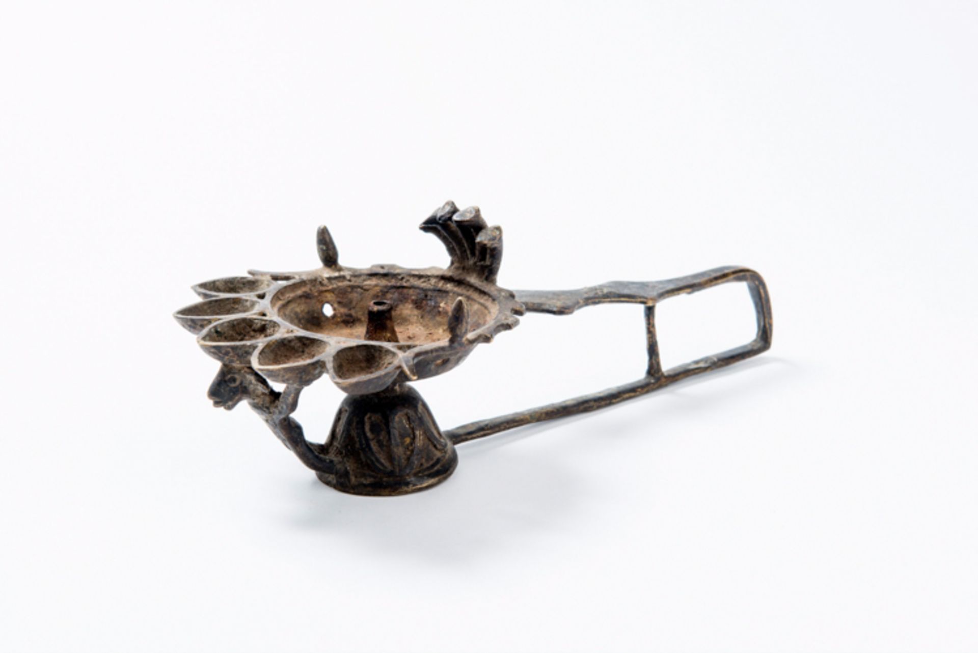 FIGURAL OIL LAMP  Bronze. Nepal, possibly 19th century  The bowl with bell-shaped foot and u-