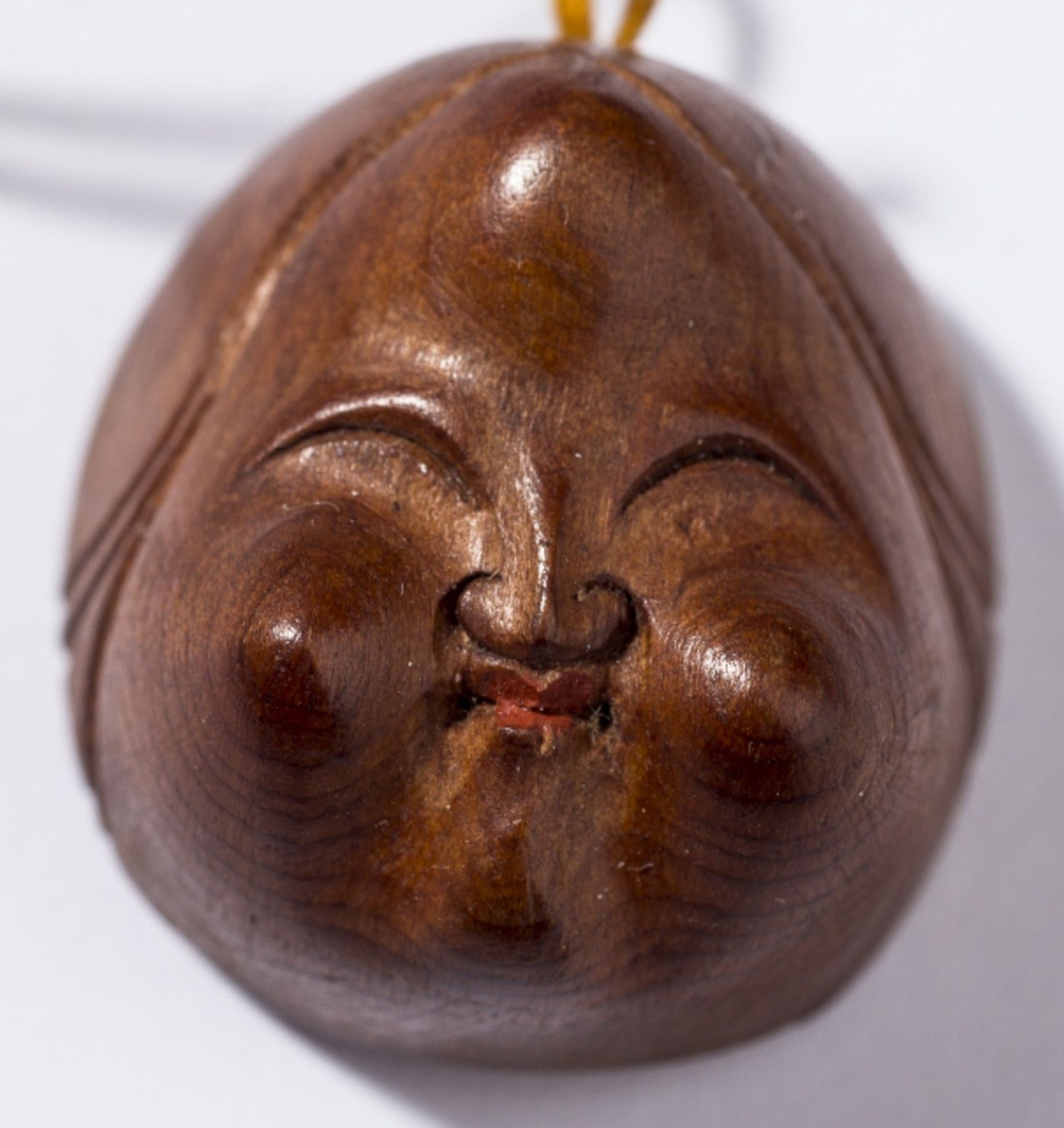 MASK SHUNGA-NETSUKE OF OKAME  Netsuke, wood, ivory. Japan, 19th cent.  Small, witty and delicate